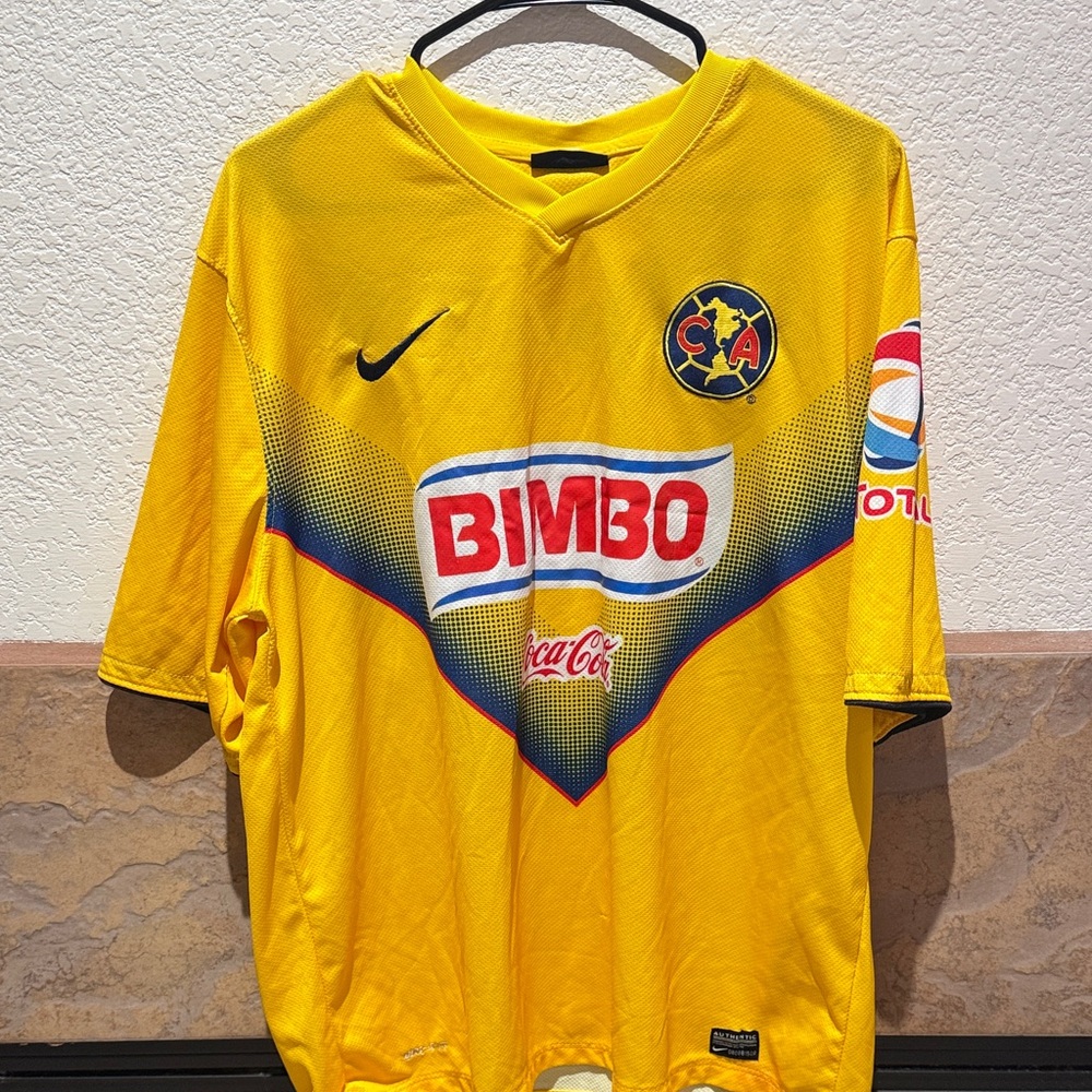 Nike Yellow Soccer Jersey with Red and Blue Accents
